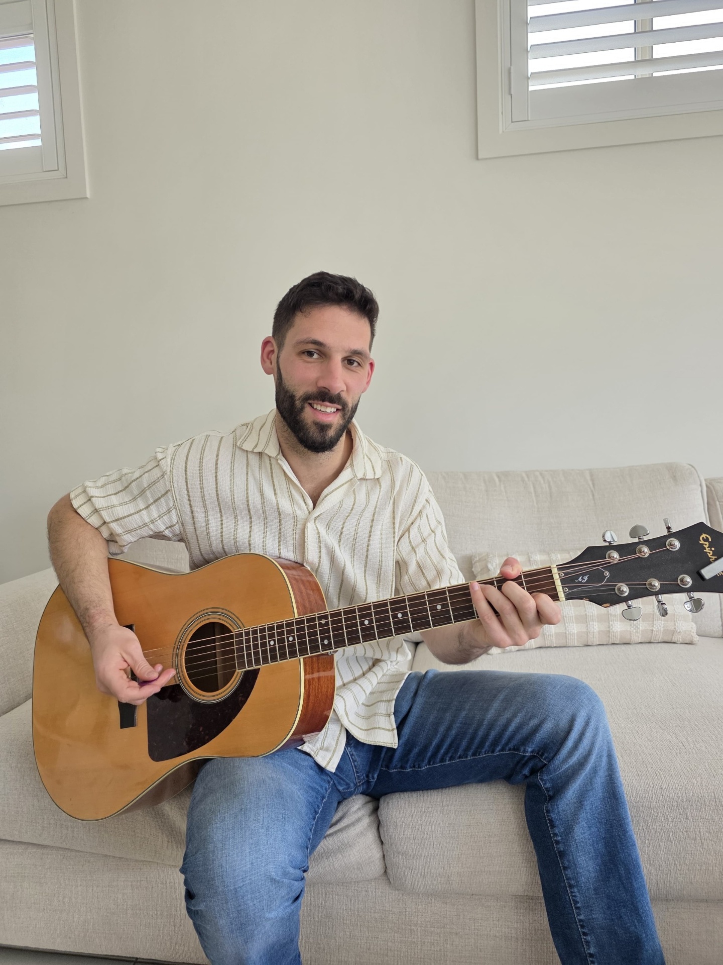 Michael, your local Lynbrook guitar teacher, playing an acoustic guitar